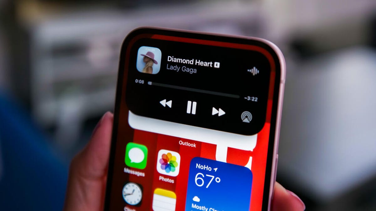 A close up of the iPhone 15's Dynamic Island playing Spotify.